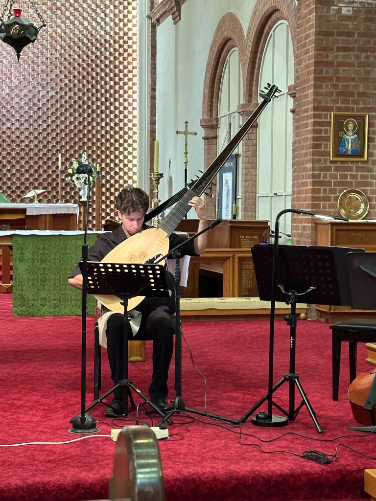 Photo of James Logan with a theorbo