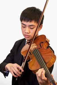 Photo of Tim Tran playing the viola